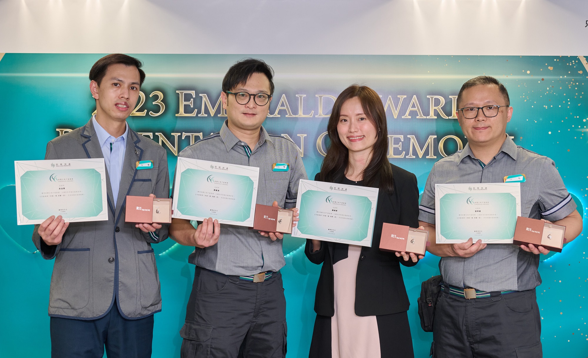 (From left) Ng Kam Fai, Ngan Chun Hung, Joey Chan and Lau Hok Lai from Amoy Gardens, Hong Kong, receive the Hang Lung Emerald Award for demonstrating their sense of mission to protect residents' health and safety. Their proactive follow-up successfully averted the potential danger of concrete falling on an elderly resident in her unit, despite the resident rejecting earlier offers of assistance