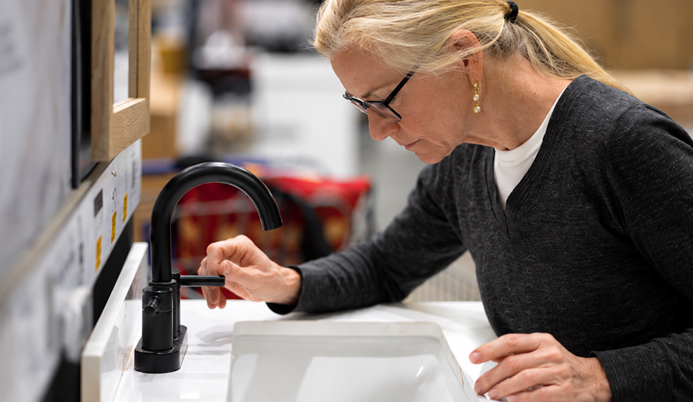 Woman Testing a Showroom Faucet