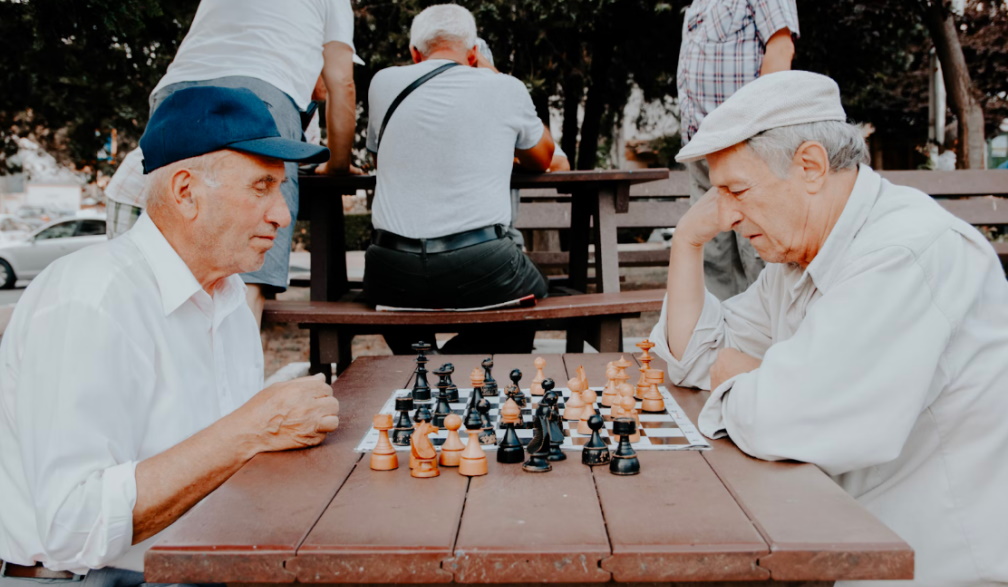 Two elderly men playing chess