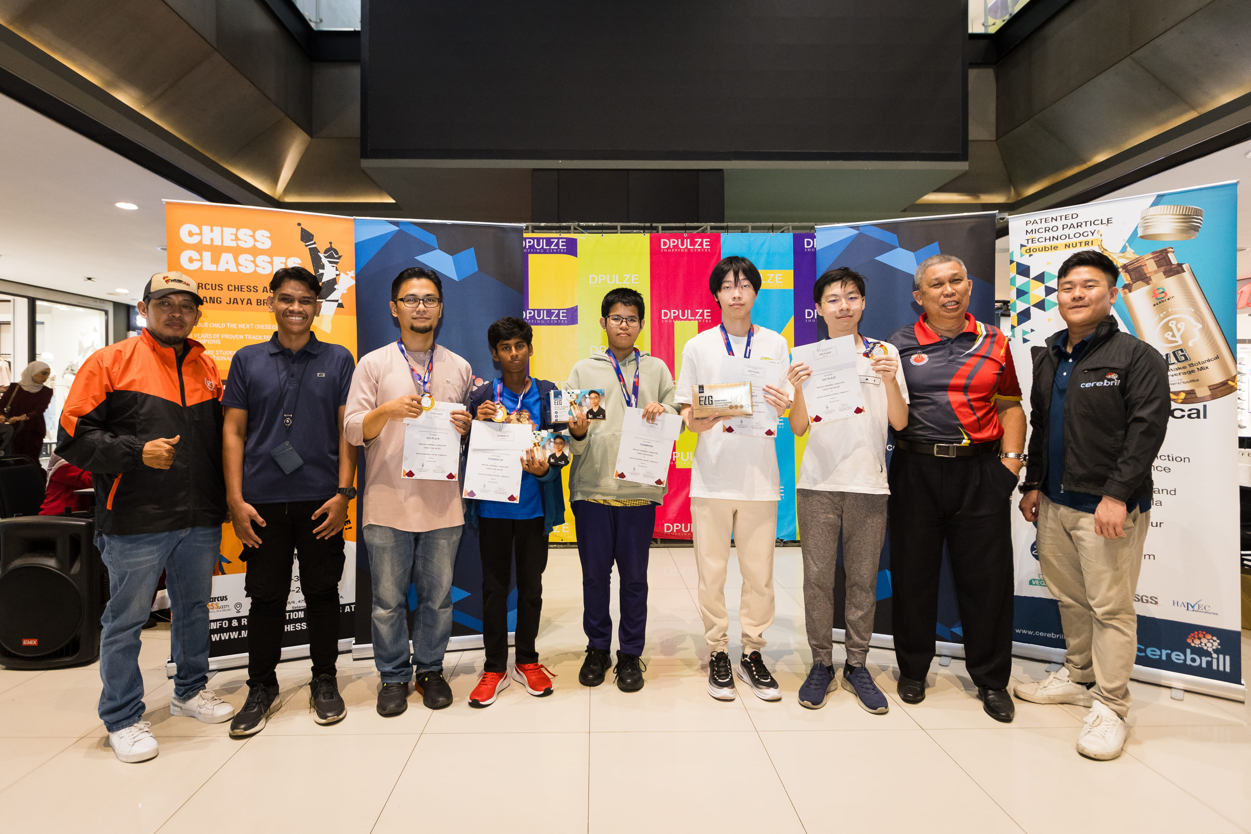 Winners at the DPulze Cerebrill Aidilfitri FIDE Rated tournament pose with their medals and certificates, joined by event co-organisers