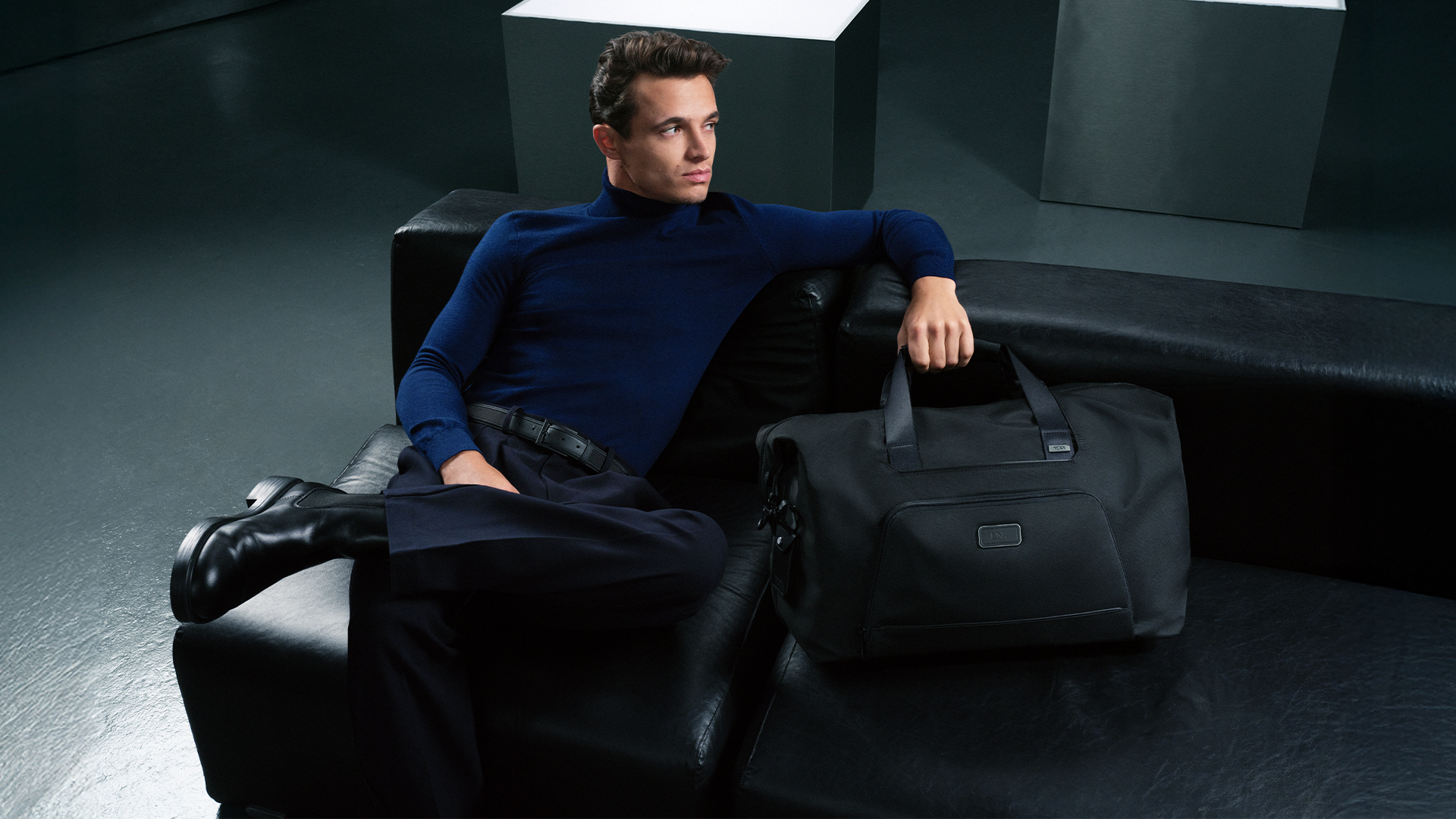 Lando Norris pictured with the Alpha Double Expansion Duffel in Black.