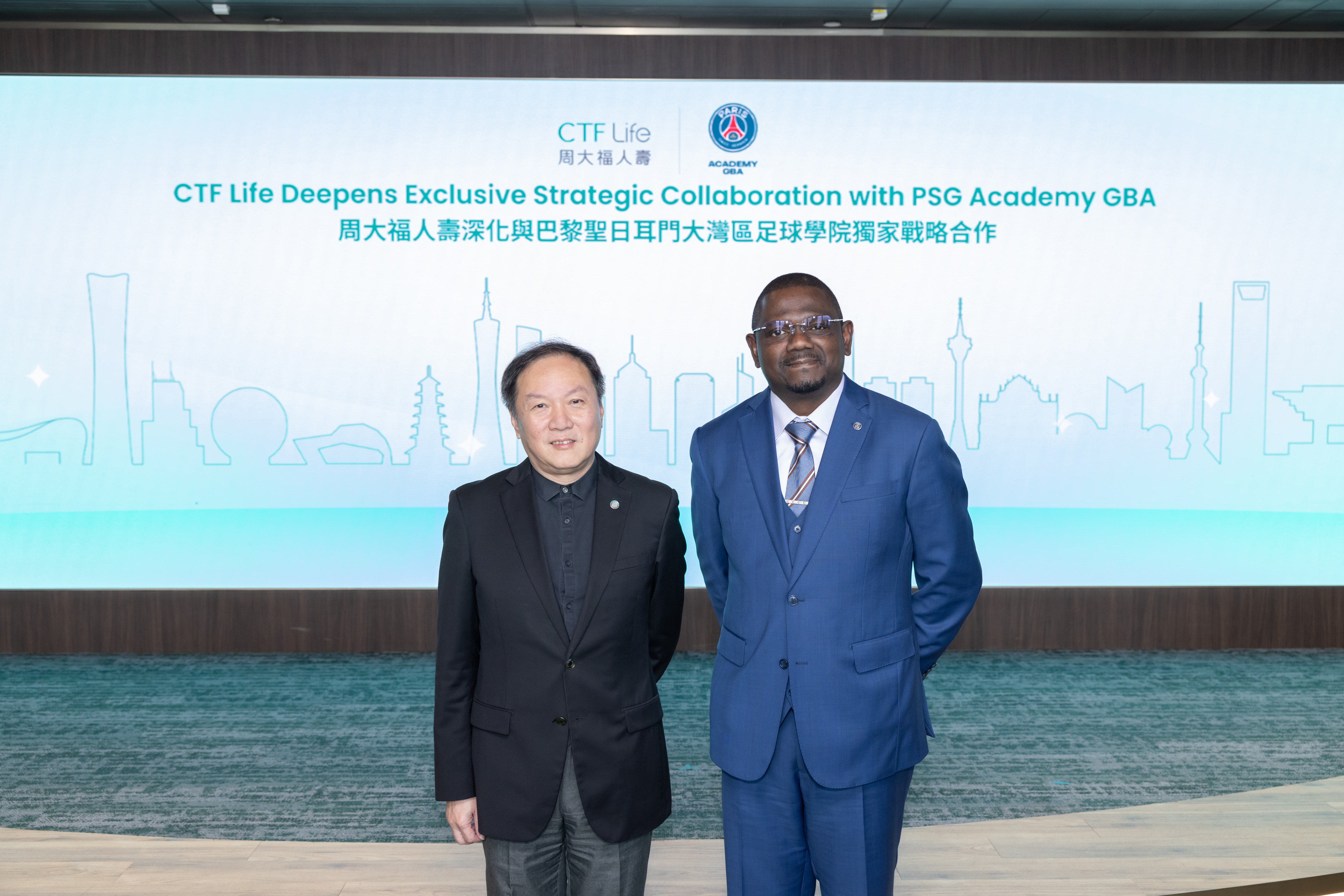 Man Kit Ip, Executive Director and Chief Executive Officer of CTF Life (left) and Yannick Ngassa, Chief Executive Officer of PSG Academy (GBA, China) (right) announce the extension of their exclusive collaboration to continue bringing Paris Saint-Germain Academy football training programmes and related sports initiatives to Hong Kong and all cities across the Chinese Mainland.